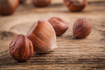 Hazelnuts (filbert) on old wooden table. Close-up