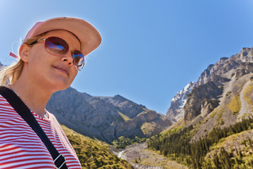Girl-traveler in the mountains