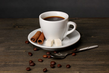 Coffee cup on wooden table on grey background