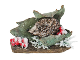 Christmas composition of hedgehog, mountain ash, stone and leaf