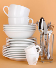 Clean white dishes on beige background