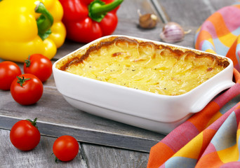 Baked potatoes with cream, garlic and black pepper. Gratin