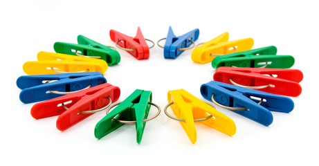 Many bright clothespins lying in a circle
