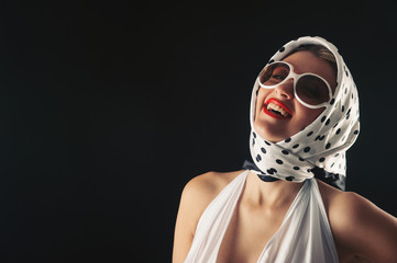 Retro woman with sunglasses laughing fashion portrait 