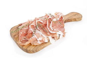 slices of italian raw ham on wooden board
