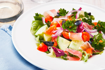 fresh vegetable salad with prosciutto ham