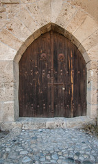Fototapeta na wymiar Closed wooden door of medieval fortress