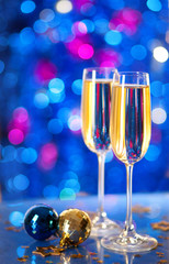 Two glasses of champagne with a Christmas decor .