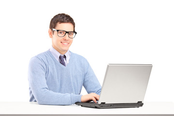 Smiling male working on a laptop