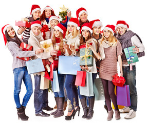 Girl in Santa hat holding Christmas gift box.