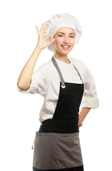 Attractive cook woman showing ok over white background