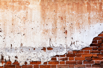 old brick wall with cracked stucco layer background