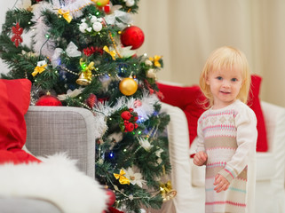 Portrait of baby girl near Christmas tree