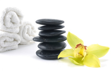 orchid and stacked stones with towel