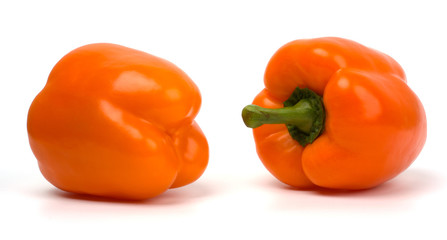 Two sweet orange peppers isolated on white