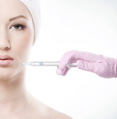 A woman on a botox injection procedure into her lips