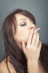 beautiful woman smokes a cigarette