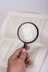 magnifying glass over book
