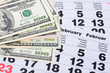 Banknotes of dollars on calendar sheets