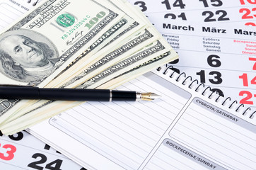 Banknotes of dollars on calendar sheets