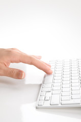 Woman's hand typing on computer keyboard