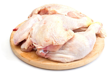 Fresh raw chicken on board isolated on white