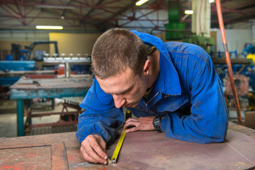 A service repairmen labouring in workshop during his shift