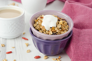 homemade granola with goji berries and yogurt in a bowl