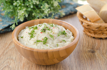 Mashed potatoes and cabbage in a bowl on a wooden table
