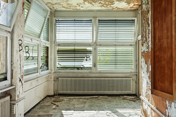 old abandoned house, windows with roller shutter broken