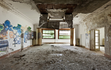 abandoned building, large room, debris on the floor