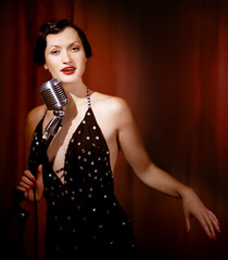 Retro singer sing holding vintage microphone