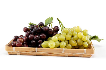 Fresh grape fruits with green leaves isolated on white backgroun