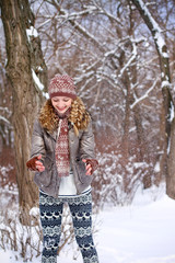 Happy young woman playing with snow outdoors