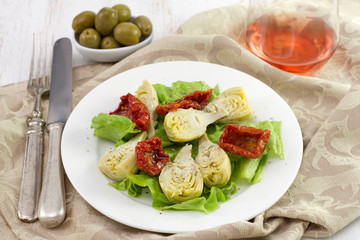 salad with artichoke on the white plate