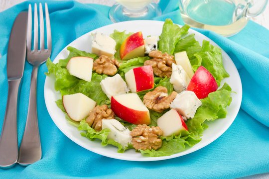 cheese salad with walnut and apple on the white plate