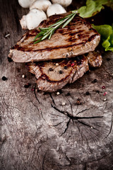 Delicious beef steaks on wood