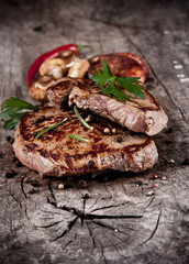 Delicious beef steaks on wood