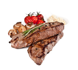 Delicious beef steaks isolated on white background