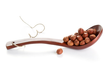 Peeled hazelnut in a spoon