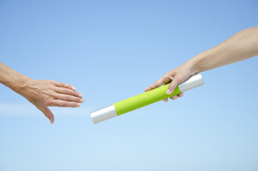 Isolated athletes hands with baton