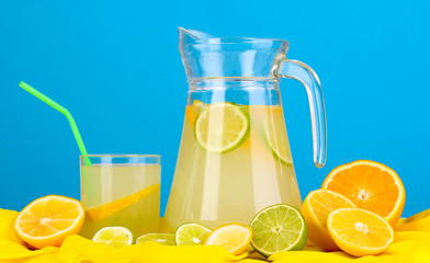 Citrus lemonade in glass and pitcher of citrus around