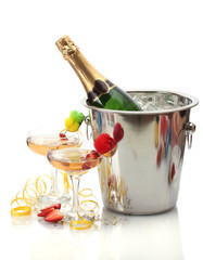 Champagne bottle in bucket with ice and glasses of champagne,