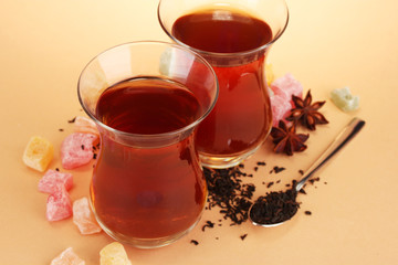 glasses of Turkish tea and rahat Delight, on beige background