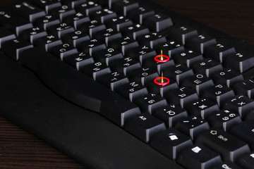 Fototapeta premium Painful typing, pins on keyboard close-up