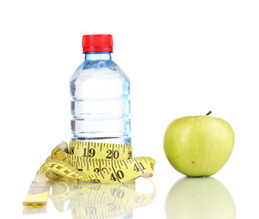 Bottle of water, apple and measuring tape isolated on white