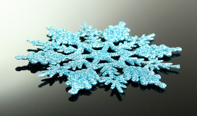 beautiful snowflake on grey background