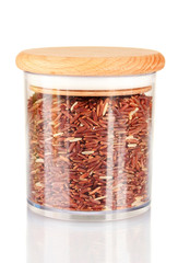 red rice in jar on white background