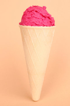 Scoop of the strawberry ice cream in the waffle cone