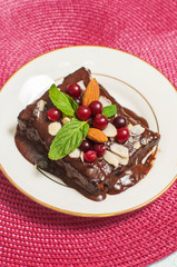 Chocolate cake with almond nuts and berries